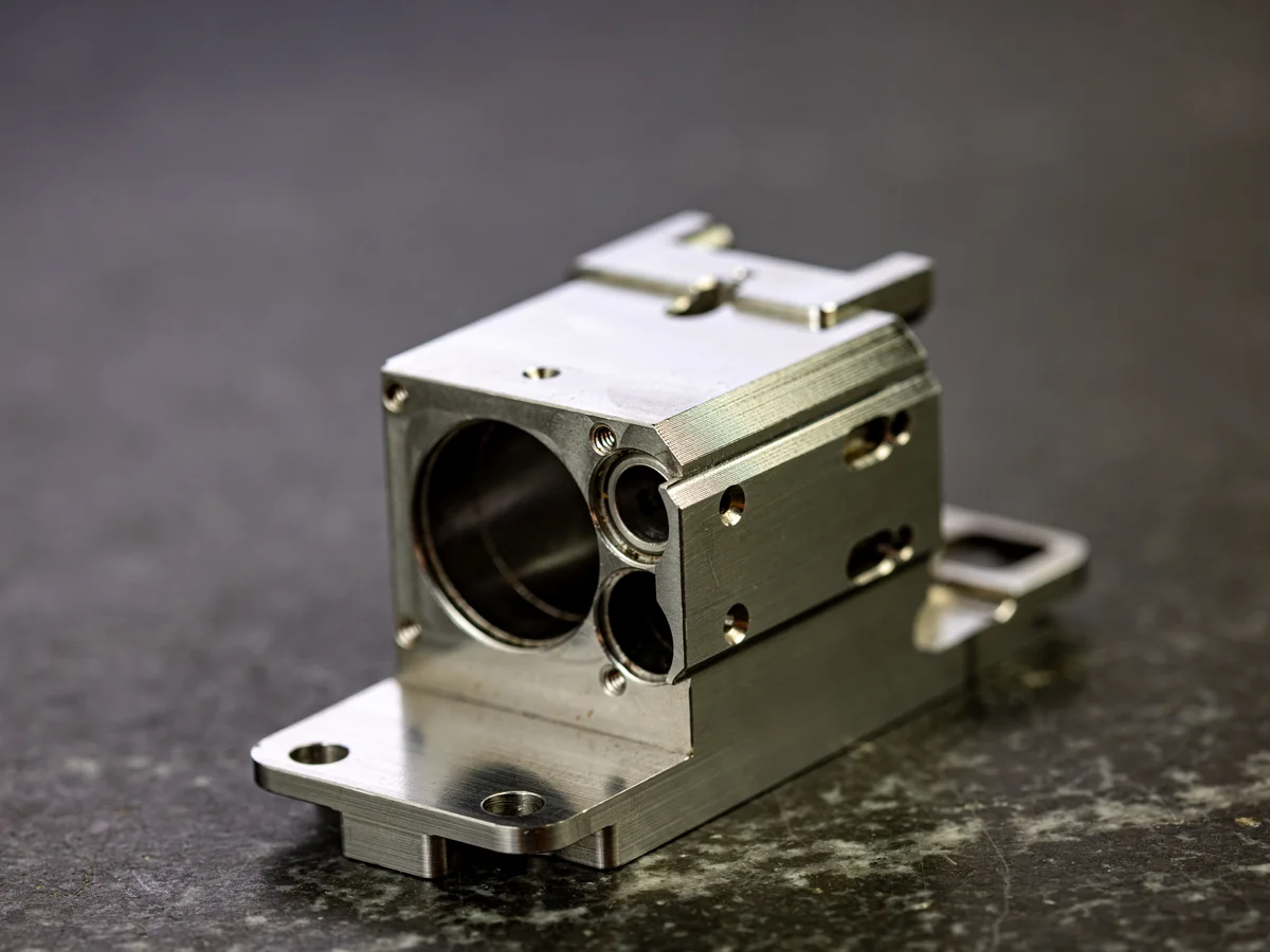 Complex multi-feature stainless housing with precision bores and mounting flanges machined by Metal Essence