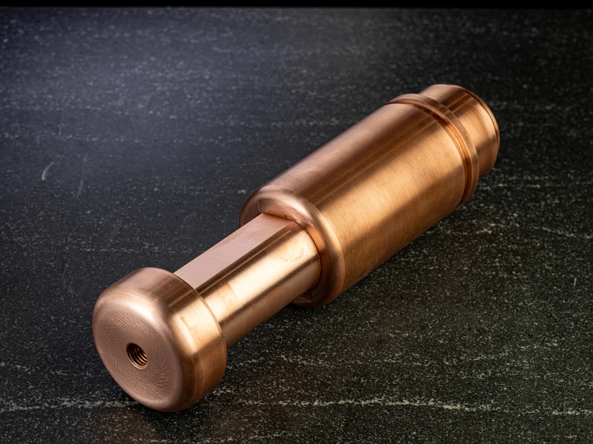 Precision turned copper component with multiple diameters machined by Metal Essence